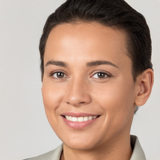 Joyful white young-adult female with short  brown hair and brown eyes