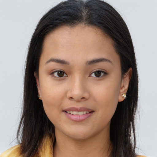 Joyful asian young-adult female with long  brown hair and brown eyes