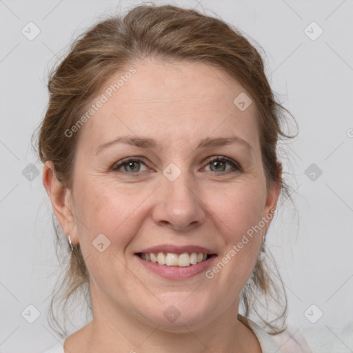 Joyful white adult female with medium  brown hair and grey eyes