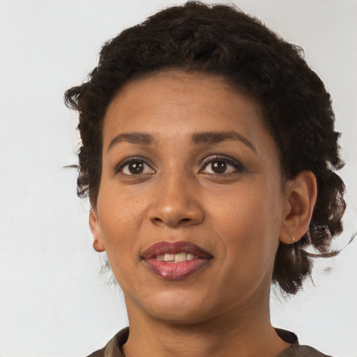 Joyful black young-adult female with short  brown hair and brown eyes