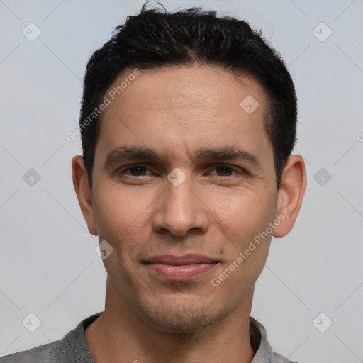 Joyful white young-adult male with short  black hair and brown eyes