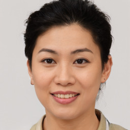 Joyful asian young-adult female with short  brown hair and brown eyes