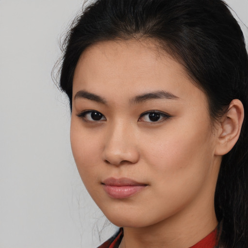 Joyful asian young-adult female with long  brown hair and brown eyes