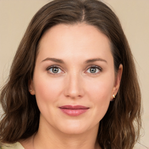 Joyful white young-adult female with medium  brown hair and green eyes