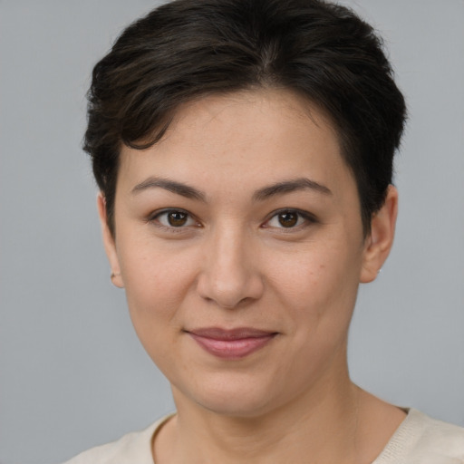 Joyful white young-adult female with short  brown hair and brown eyes