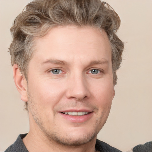 Joyful white adult male with short  brown hair and grey eyes