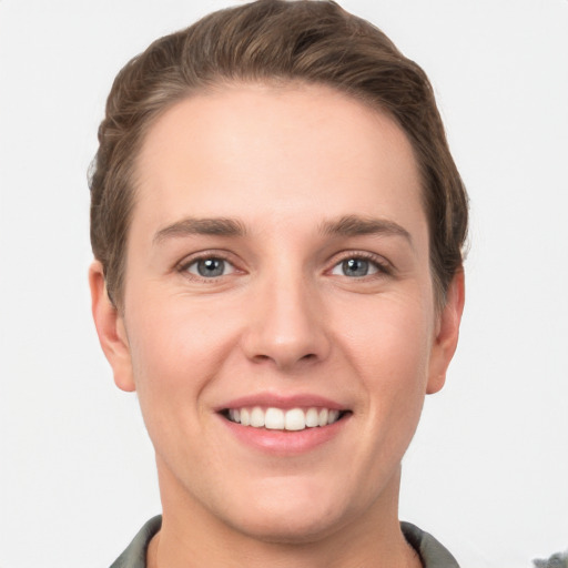 Joyful white young-adult female with short  brown hair and grey eyes