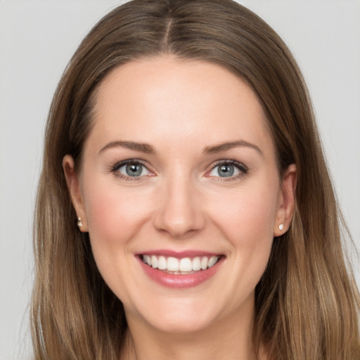 Joyful white young-adult female with long  brown hair and grey eyes