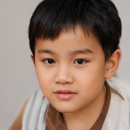 Neutral asian child male with short  brown hair and brown eyes