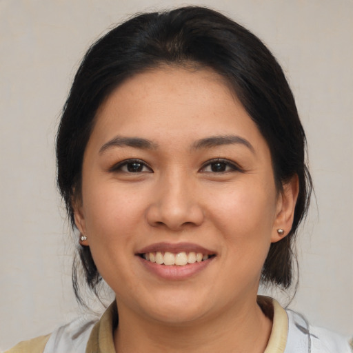 Joyful asian young-adult female with medium  brown hair and brown eyes