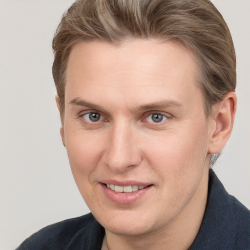 Joyful white adult male with short  brown hair and grey eyes