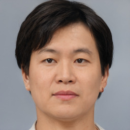 Neutral asian adult male with short  brown hair and brown eyes