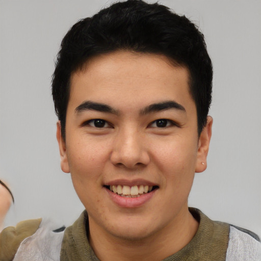 Joyful asian young-adult male with short  black hair and brown eyes