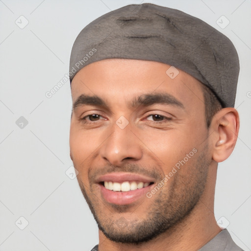 Joyful white young-adult male with short  black hair and brown eyes