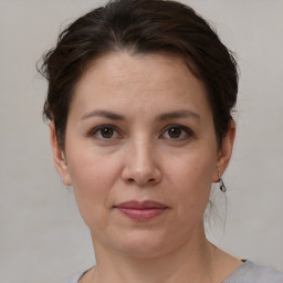 Joyful white adult female with short  brown hair and brown eyes