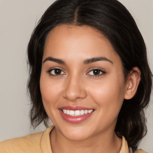 Joyful white young-adult female with medium  brown hair and brown eyes