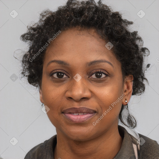 Joyful black adult female with medium  brown hair and brown eyes