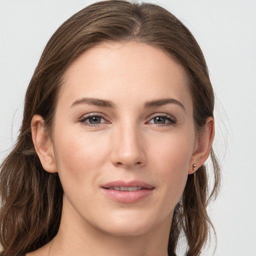 Joyful white young-adult female with long  brown hair and grey eyes