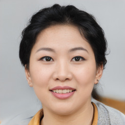 Joyful asian young-adult female with short  brown hair and brown eyes