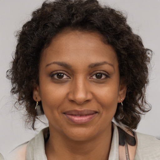 Joyful black young-adult female with medium  brown hair and brown eyes