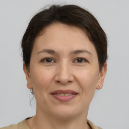 Joyful white adult female with short  brown hair and brown eyes