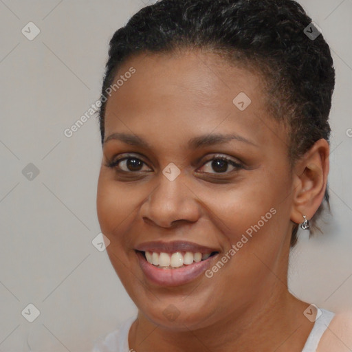 Joyful black young-adult female with short  brown hair and brown eyes