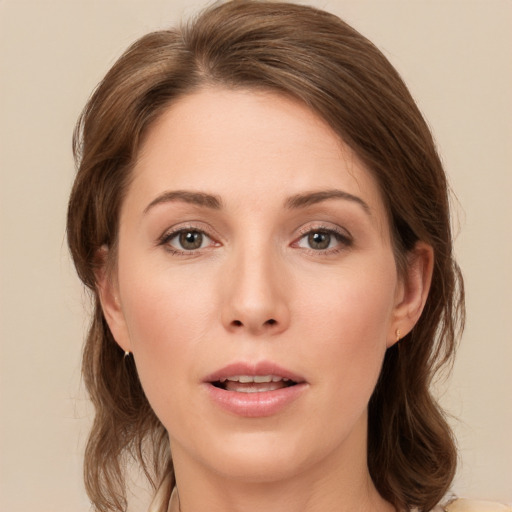 Joyful white young-adult female with medium  brown hair and grey eyes