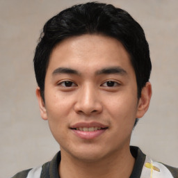 Joyful asian young-adult male with short  black hair and brown eyes