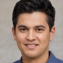 Joyful white young-adult male with short  black hair and brown eyes