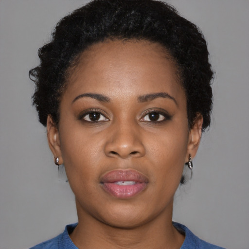 Joyful black young-adult female with short  brown hair and brown eyes