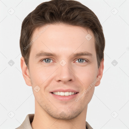 Joyful white young-adult male with short  brown hair and grey eyes