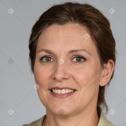 Joyful white adult female with medium  brown hair and grey eyes