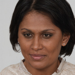 Joyful white adult female with medium  brown hair and brown eyes