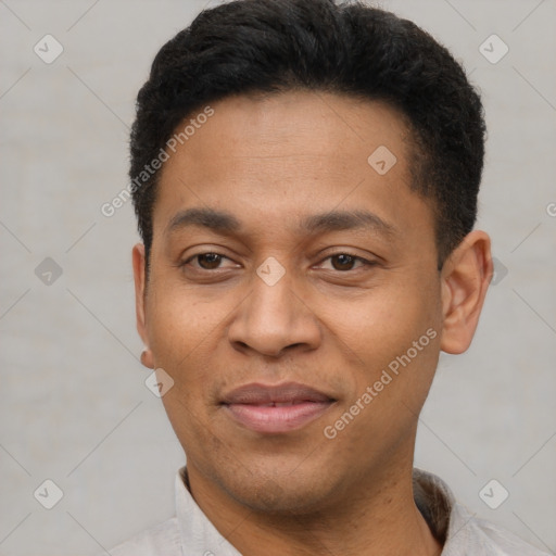 Joyful latino adult male with short  black hair and brown eyes