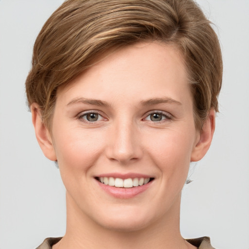 Joyful white young-adult female with short  brown hair and grey eyes