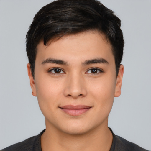 Joyful asian young-adult male with short  brown hair and brown eyes