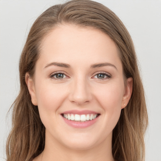 Joyful white young-adult female with long  brown hair and grey eyes