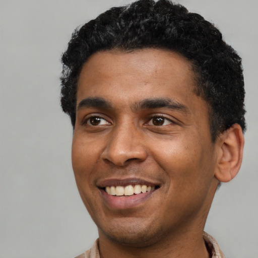 Joyful latino young-adult male with short  black hair and brown eyes
