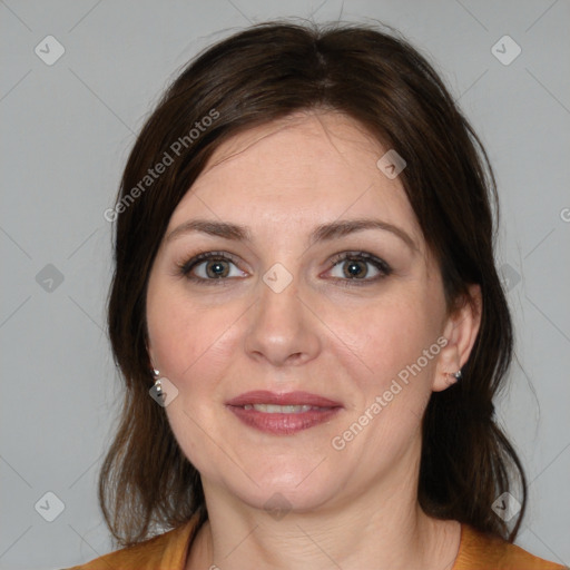 Joyful white adult female with medium  brown hair and brown eyes