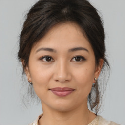 Joyful asian young-adult female with medium  brown hair and brown eyes