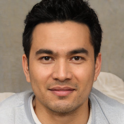 Joyful asian young-adult male with short  black hair and brown eyes