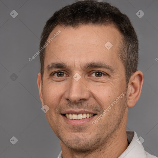 Joyful white adult male with short  brown hair and brown eyes