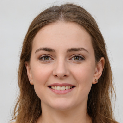 Joyful white young-adult female with long  brown hair and grey eyes