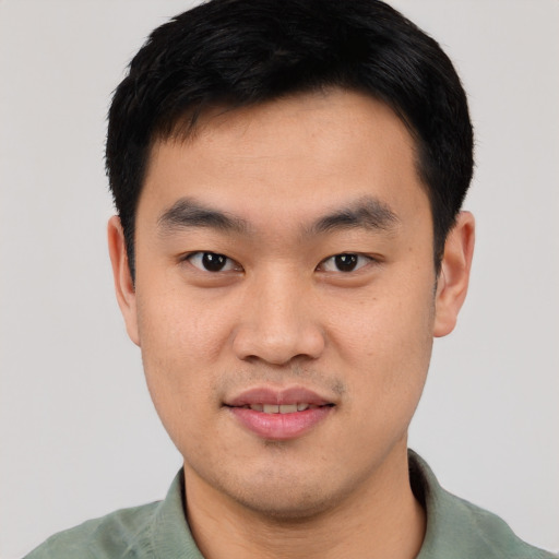 Joyful asian young-adult male with short  black hair and brown eyes