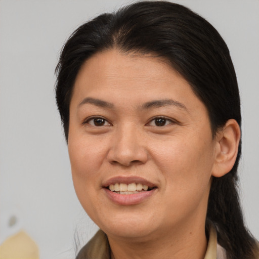 Joyful asian adult female with long  brown hair and brown eyes
