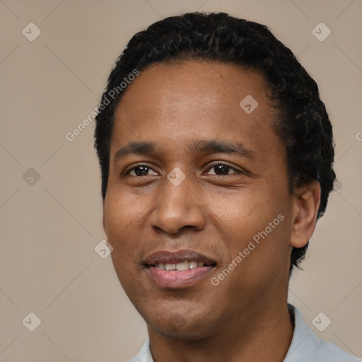 Joyful black young-adult male with short  black hair and brown eyes