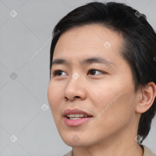 Joyful asian young-adult male with short  brown hair and brown eyes