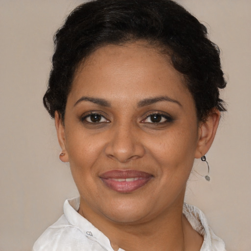 Joyful latino adult female with short  brown hair and brown eyes