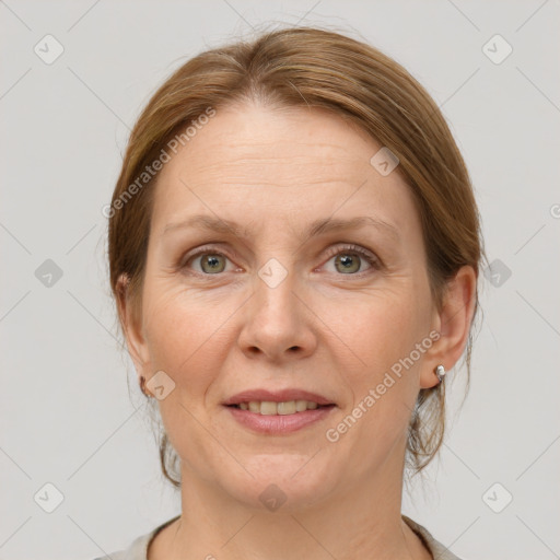 Joyful white adult female with medium  brown hair and grey eyes