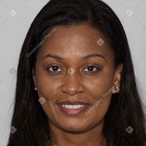 Joyful black young-adult female with long  brown hair and brown eyes